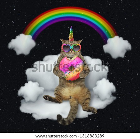 The cat unicorn in sunglasses with a color donut is sitting on the cloud like a couch. The rainbow is behind him. Stars background.