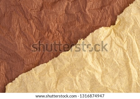 Multi-colored crumpled real vivid paper sheets texture background. Brown, beige.