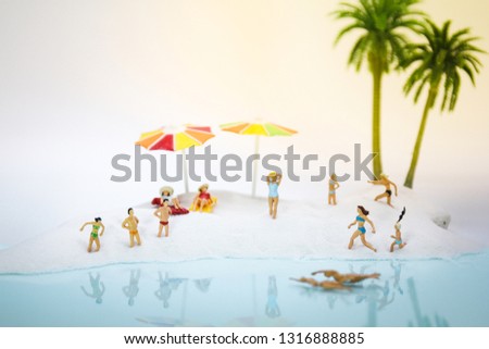 Miniature people: Sandy beach with tourists using as background traveling, exploring the world, business travel trip concept. - Image