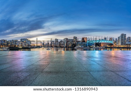 empty concrete square floor with skyline background at night, vancouver, canada. Royalty-Free Stock Photo #1316890943