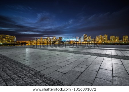 empty concrete square floor with skyline background at night, vancouver, canada. Royalty-Free Stock Photo #1316891072