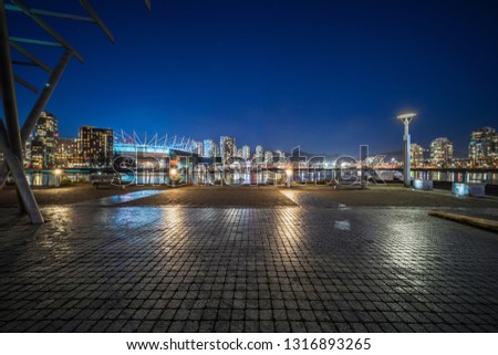 empty concrete square floor with skyline background at night, vancouver, canada. Royalty-Free Stock Photo #1316893265
