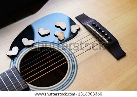 Wooden hearts on guitar, on pic guard.  Love music concept.