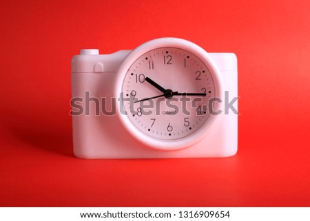 White analog clock on red background