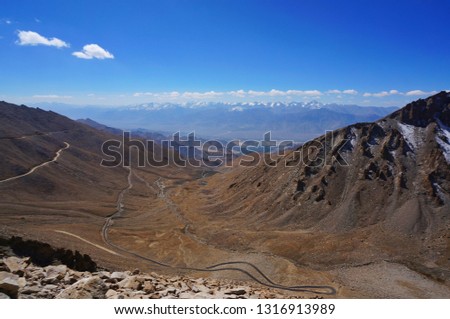 Curve of Leh's road along the valleys with snow mountain panorama background in Leh, Ladakh, India 