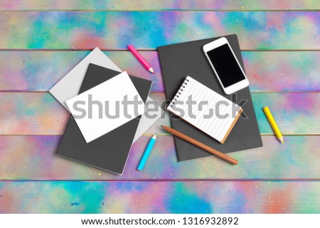 smartphone, tablet, notebook  pen on the background of a wooden table