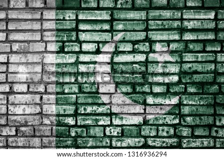 National flag of Pakistan on a brick background. Concept image for  Pakistan: language , people and culture.