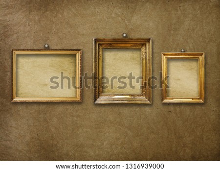 Old vintage gold ornate frame for picture on grunge stone wall