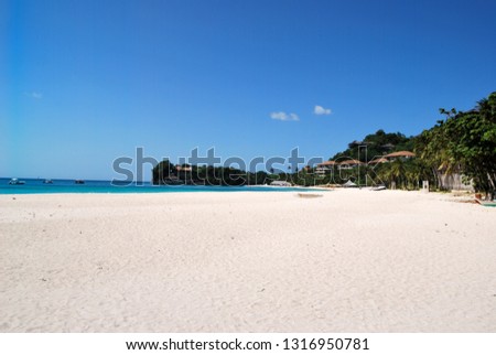 Beach paradise at Puerto Galera is municipality in province of Oriental Mindoro, Philippines. It is located near Isla Verde Passage and Manila. Blue sky, palm trees and clear water. Sunny summer day.
