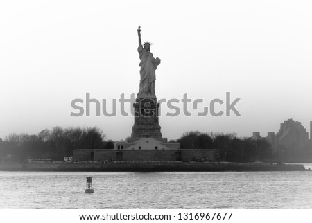 Beautiful view of American symbol Statue of Liberty silhouette in New York, USA. High key black and white image.