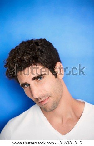 Handsome dude on blue background, portrait