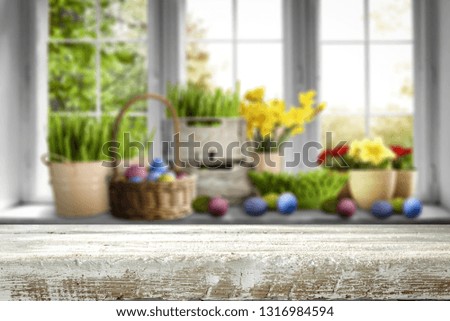 Desk of free space and Easter time. Blurred background of window. 
