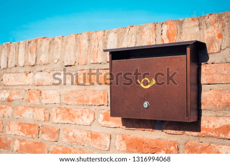 Modern metal mail box on brick stone wall