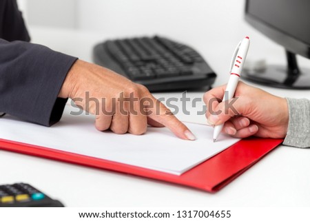 Contract closing in a business office, signature on a empty document, copyspace