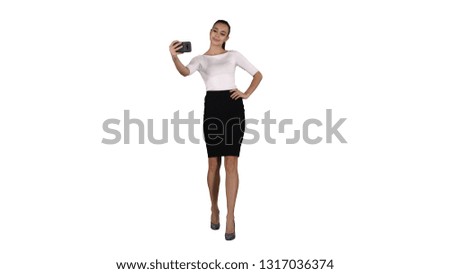 Smiling attractive woman taking a selfie while walking on white background.