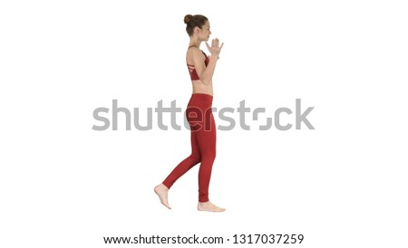 Young woman practicing breathing exercise and walking on white background.