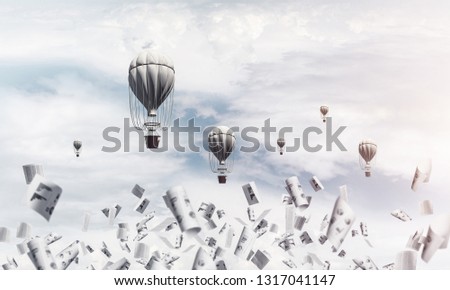 Colorful aerostats flying among paper documents and over the blue cloudy sky. 3D rendering.