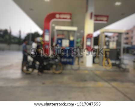 Defocused image, Customers who use services in the petroleum station.