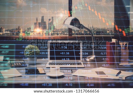 Double exposure of stock market chart and office desktop on background. financial strategy concept.