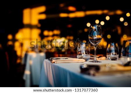 Luxury table settings for fine dining with and glassware, beautiful blurred  background. For events, weddings.  Preparation for holiday  passover, props for weddings, birthdays, and celebrations. Royalty-Free Stock Photo #1317077360