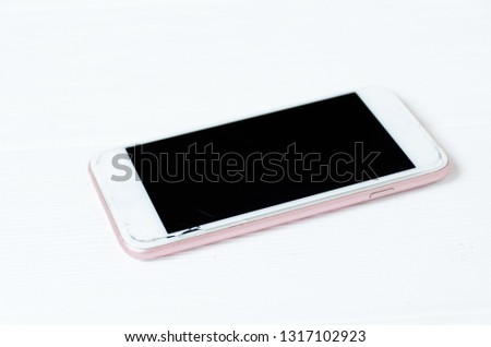Broken phone screen on wooden background. Concept of repair