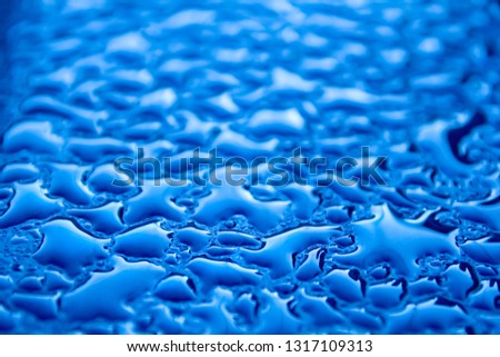 Drops of water on the wall with a new day. Closeup. Beautiful pattern for the surface background.