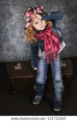 portrait of a cute little girl with blond curly hair