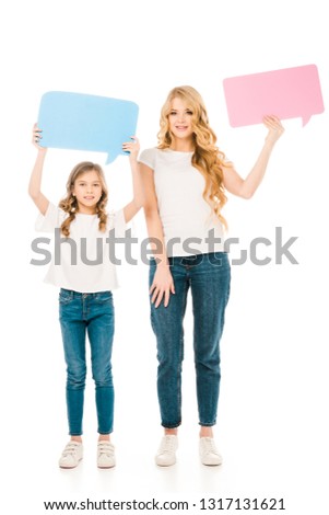 pretty mother and cute child holding speech bubbles isolated on white