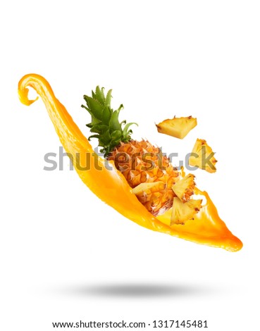 Flying in air fresh ripe whole and cut baby Pineapple with juice splash isolated on white background. High resolution image