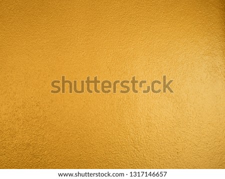 Gold color background. Rough gold texture design on the wall.