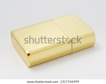 golden gasoline lighter with a wick on a white background.