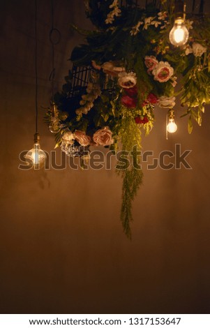 Roses on a wall ornament with light bulbs
