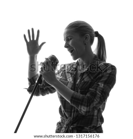 Silhouette of female singer on white background