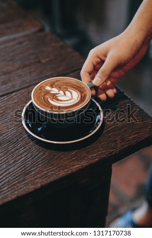A cup of coffee on the  wooden table 
