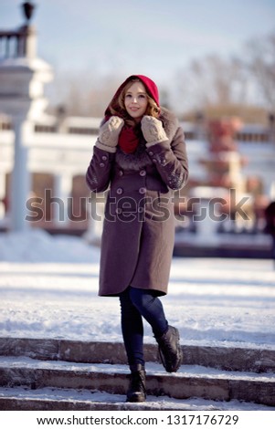 Young girl on a winter walk in a city park