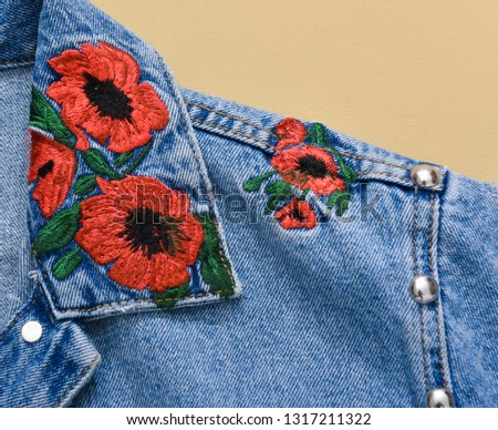 Blue embroidered floral jacket jeans s with a seam.-front view

