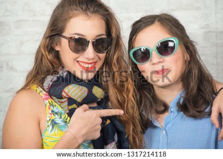 portrait of a pretty beautiful charming adorable with long hair girl and her older friend