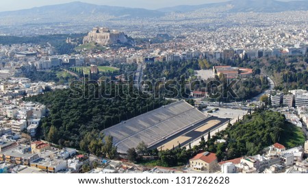 Aerial drone photo of iconic ancient Panathenaic stadium or Kalimarmaro as seen from distance and Acropolis hill, Zappeion at the background, Athens historic centre, Attica, Greece
