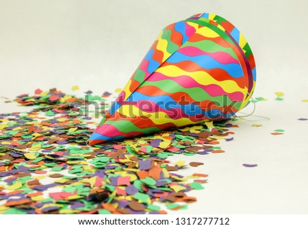 Confetti and colorful hats on white background