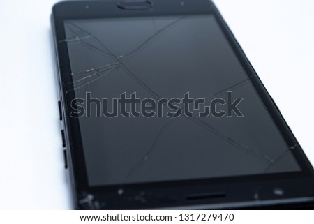Broken and scratched cellphone on the white background