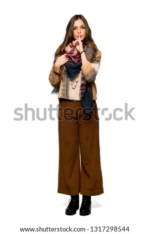 Full-length shot of Young hippie woman showing a sign of silence gesture putting finger in mouth on isolated white background