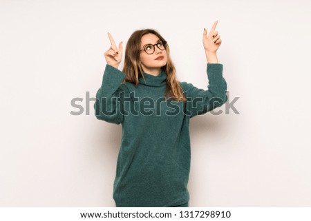 Teenager girl over white wall pointing with the index finger a great idea