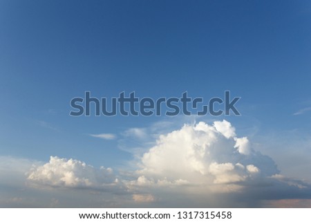Fluffy white clouds in the blue sky