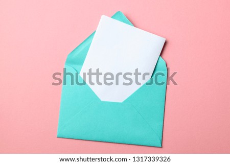 Green envelope and blank letter on pink background.