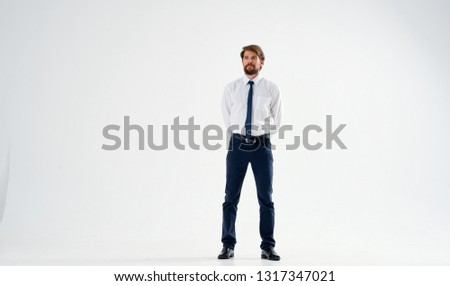 Business man in suit with tie holds hands behind his back office worker