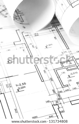 Architectural background with rolls of drawings