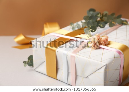 Festive gift box on table, closeup