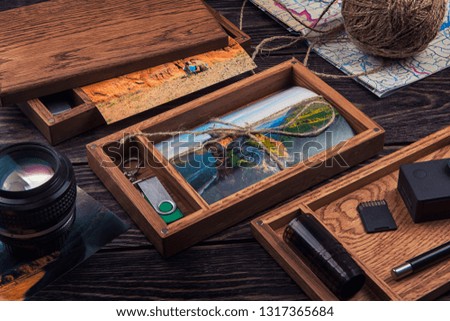 Wooden photo box with photo from travel. Decorated with different things. Travel concept.