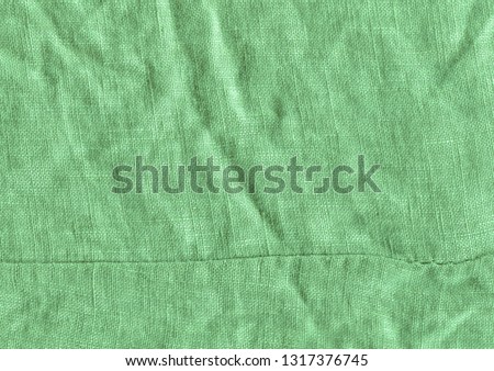 Green fabric surface for background. Green linen texture. Green flaxen background  