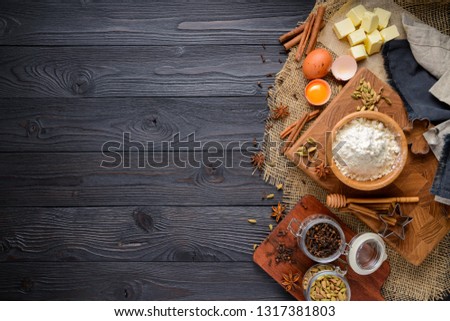 ingredients for baking ginger cookies on a rustic wooden background, view from above